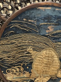 A Chinese wooden table screen with an embroidered silk with turtle design, 19th C.