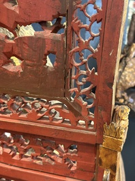 A pair of Chinese gilt-lacquered openworked wooden table screens with warriors on horseback, 19th C.