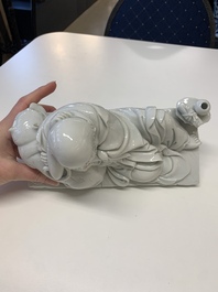 A Chinese Dehua blanc de Chine figure of a Luohan reclining on a tiger, Dehua and Bo Ji Yu Ren 博及漁人 mark, 20th C.