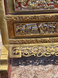 A pair of Chinese gilt-lacquered openworked wooden table screens with warriors on horseback, 19th C.