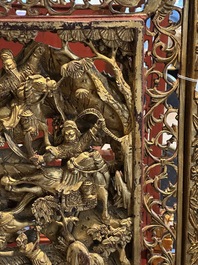 A pair of Chinese gilt-lacquered openworked wooden table screens with warriors on horseback, 19th C.