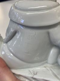 A Chinese Dehua blanc de Chine figure of a Luohan reclining on a tiger, Dehua and Bo Ji Yu Ren 博及漁人 mark, 20th C.