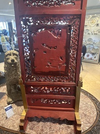 A pair of Chinese gilt-lacquered openworked wooden table screens with warriors on horseback, 19th C.