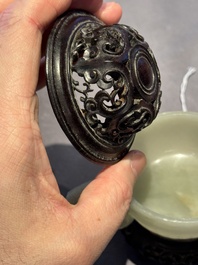 A Chinese white jade bowl with ruyi-shaped handles, wooden cover and stand, 18/19th C.