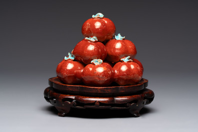 A pair of Chinese polychrome 'persimmons' groups on wooden stands, 19th C.