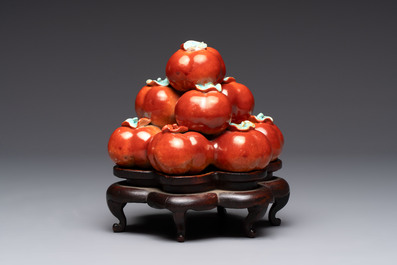 A pair of Chinese polychrome 'persimmons' groups on wooden stands, 19th C.