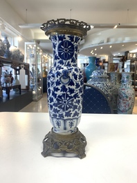 A pair of Chinese blue and white bronze-mounted vases and a covered jar, 19th C.