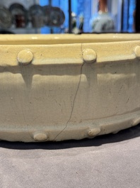 A large Chinese cream-glazed drum-shaped basin, Ming