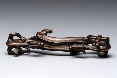A Chinese bronze 'dragon' brush rest, Song/Yuan