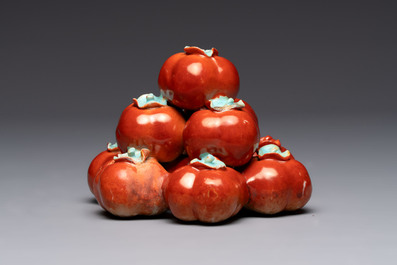 A pair of Chinese polychrome 'persimmons' groups on wooden stands, 19th C.