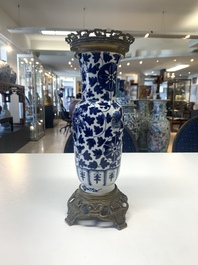 A pair of Chinese blue and white bronze-mounted vases and a covered jar, 19th C.