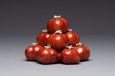 A pair of Chinese polychrome 'persimmons' groups on wooden stands, 19th C.