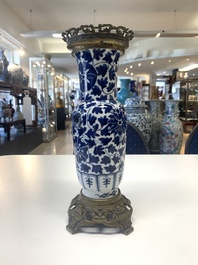 A pair of Chinese blue and white bronze-mounted vases and a covered jar, 19th C.