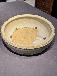 A large Chinese cream-glazed drum-shaped basin, Ming