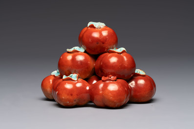 A pair of Chinese polychrome 'persimmons' groups on wooden stands, 19th C.