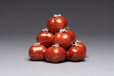 A pair of Chinese polychrome 'persimmons' groups on wooden stands, 19th C.