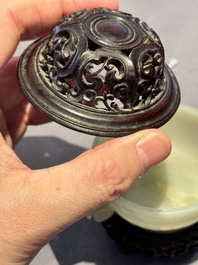 A Chinese white jade bowl with ruyi-shaped handles, wooden cover and stand, 18/19th C.
