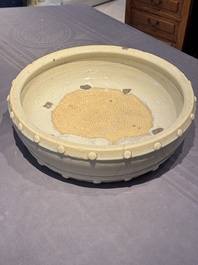 A large Chinese cream-glazed drum-shaped basin, Ming