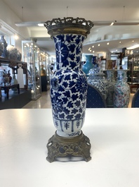 A pair of Chinese blue and white bronze-mounted vases and a covered jar, 19th C.
