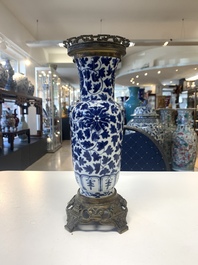 A pair of Chinese blue and white bronze-mounted vases and a covered jar, 19th C.