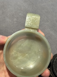 A Chinese white jade bowl with ruyi-shaped handles, wooden cover and stand, 18/19th C.