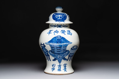 A Chinese blue and white vase and cover with calligraphy and antiquities, 19th C.