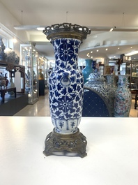 A pair of Chinese blue and white bronze-mounted vases and a covered jar, 19th C.