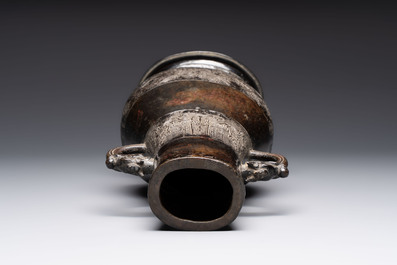 A fine Chinese archaistic bronze 'hu' vase with dragon handles, Yuan