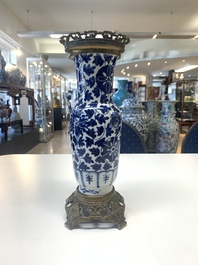 A pair of Chinese blue and white bronze-mounted vases and a covered jar, 19th C.