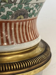 A Chinese famille verte vase and two covered vases, 19th C.