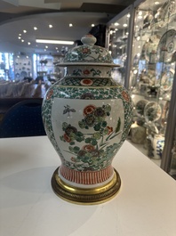 A Chinese famille verte vase and two covered vases, 19th C.