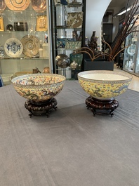 Two Chinese eggshell famille rose 'dragon' bowls on wooden stands, Qianlong mark, 20th C.