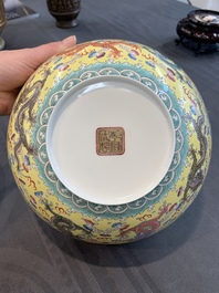 Two Chinese eggshell famille rose 'dragon' bowls on wooden stands, Qianlong mark, 20th C.