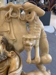A Chinese carved group of a Luohan with two tigers, 20th C.