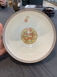 Two Chinese eggshell famille rose 'dragon' bowls on wooden stands, Qianlong mark, 20th C.