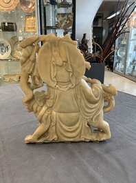 A Chinese carved group of a Luohan with two tigers, 20th C.