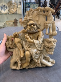 A Chinese carved group of a Luohan with two tigers, 20th C.