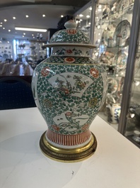 A Chinese famille verte vase and two covered vases, 19th C.