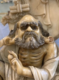 A Chinese carved group of a Luohan with two tigers, 20th C.