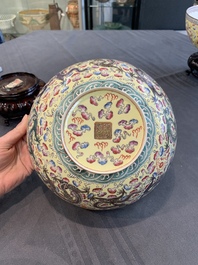 Two Chinese eggshell famille rose 'dragon' bowls on wooden stands, Qianlong mark, 20th C.