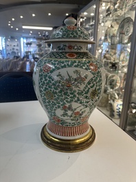 A Chinese famille verte vase and two covered vases, 19th C.