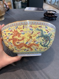 Two Chinese eggshell famille rose 'dragon' bowls on wooden stands, Qianlong mark, 20th C.