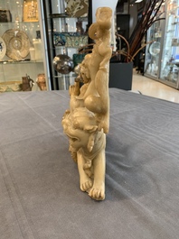 A Chinese carved group of a Luohan with two tigers, 20th C.