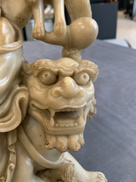 A Chinese carved group of a Luohan with two tigers, 20th C.