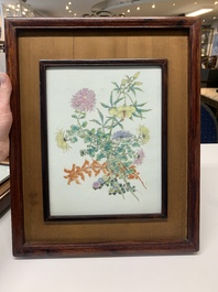 A pair of Chinese famille rose plaques in wooden frames, 20th C.