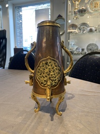 A rare and fine Chinese partly-gilt copper chocolate pot with tripod stand, 18th C.