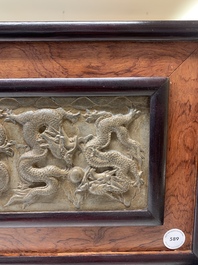 A Chinese wooden table screen with a carved stone 'dragon' plaque, 20th C.