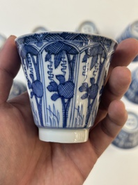 11 Japanese blue and white cups and 12 saucers with floral design, Chenghua mark, Meiji, 19th C.