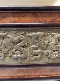 A Chinese wooden table screen with a carved stone 'dragon' plaque, 20th C.