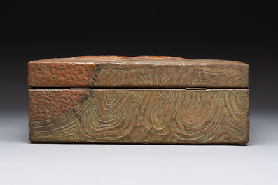 Alfred Daguet (Paris, 1875-1942): An Art Nouveau repouss&eacute; brass- and copper-mounted box with 'crabs' design and inset glass eyes, ca. 1900